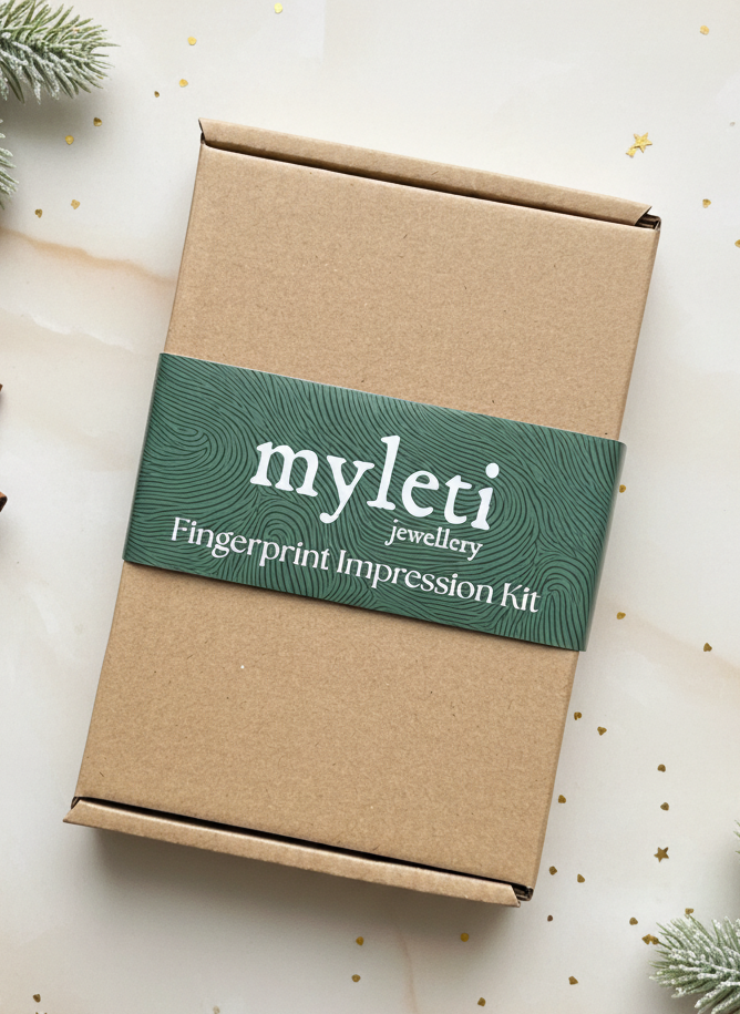 Myleti fingerprint jewellery impression kit box on a decorative surface with greenery 