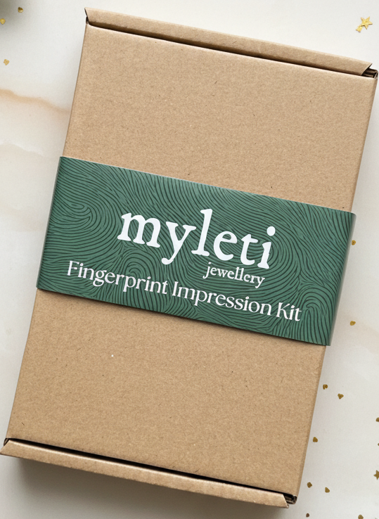 Myleti fingerprint jewellery impression kit box on a decorative surface with greenery 